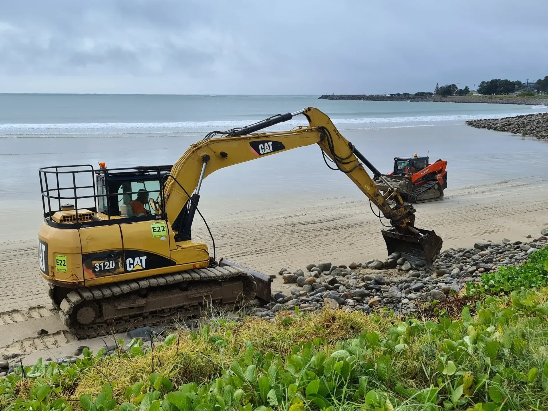 Yellow Excavator Working on A Beach — Jim Anderson Earthmoving Pty Ltd in Coopernook, NSW