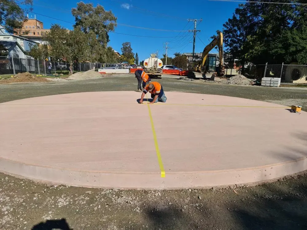 Workers on A Circular Concrete Pad — Jim Anderson Earthmoving Pty Ltd in Coopernook, NSW