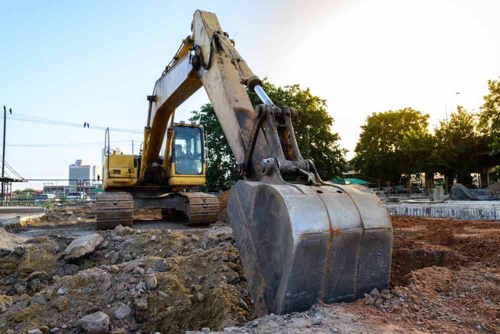 Yellow Excavator Digging in Dirt at a Construction Site — Jim Anderson Earthmoving Pty Ltd In Bulahdelah, NSW