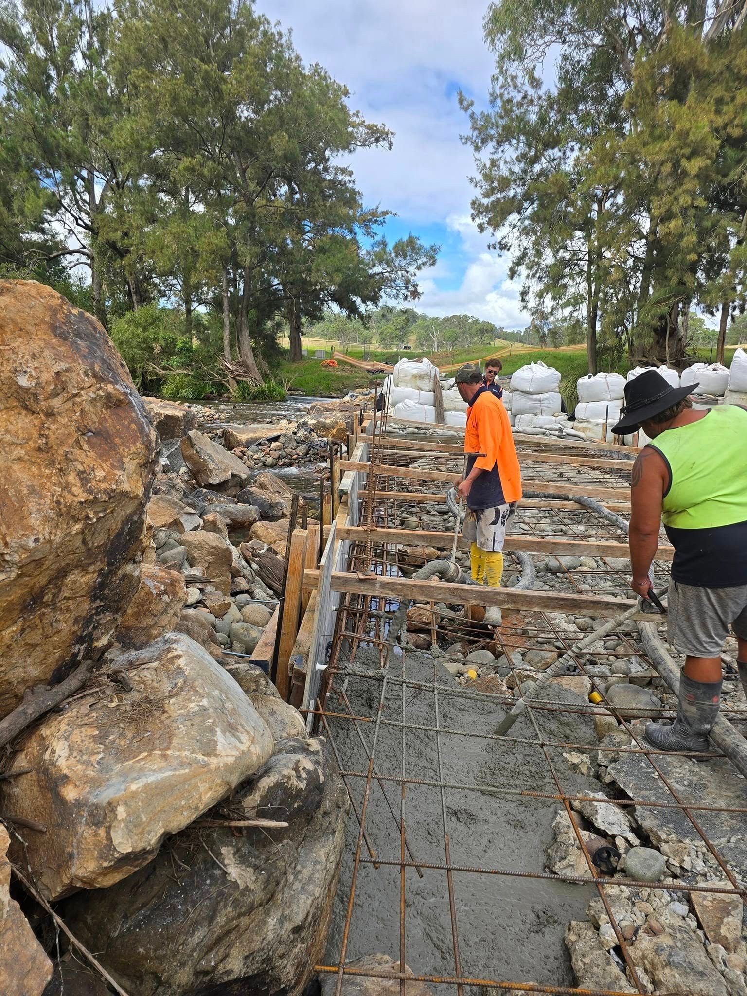 Construction workers in high-vis vests build a concrete structure with rebar — Jim Anderson Earthmoving Pty Ltd In Coopernook, NSW