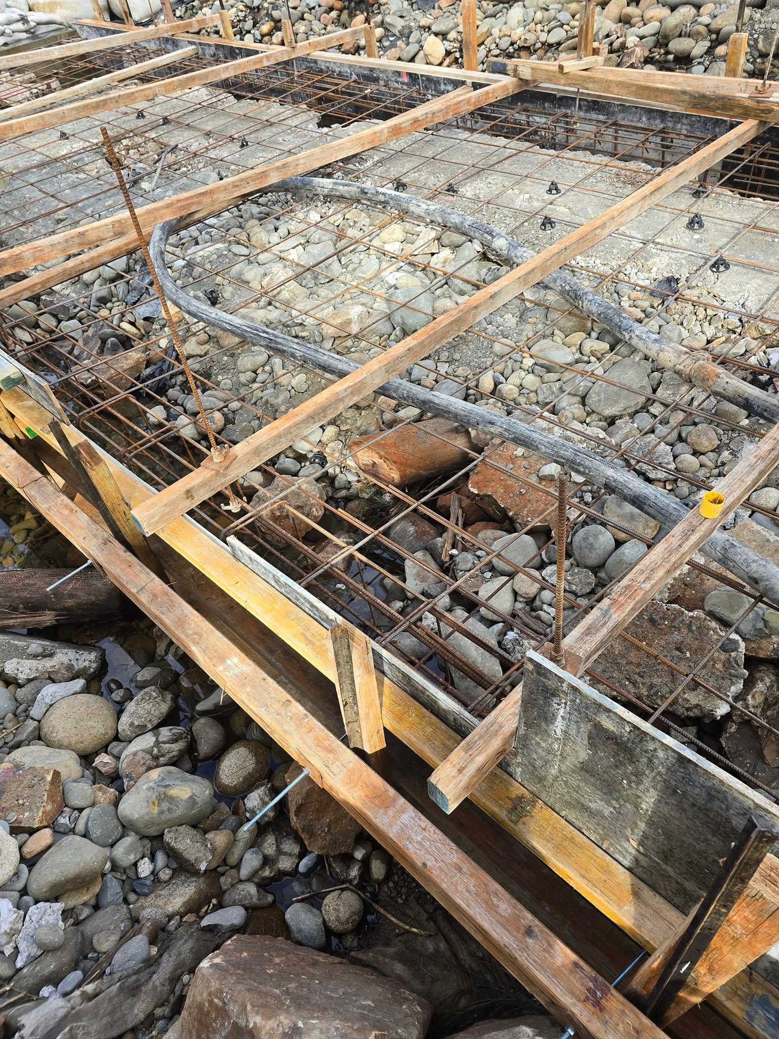 Construction site with wooden forms, rebar, gravel base, and pipes prepared for concrete pouring — Jim Anderson Earthmoving Pty Ltd In Coopernook, NSW