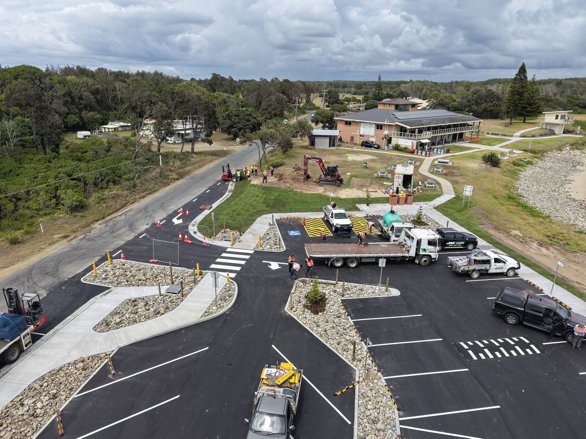 Aerial view of a parking lot under construction near a body of water and building — Jim Anderson Earthmoving Pty Ltd In Coopernook, NSW