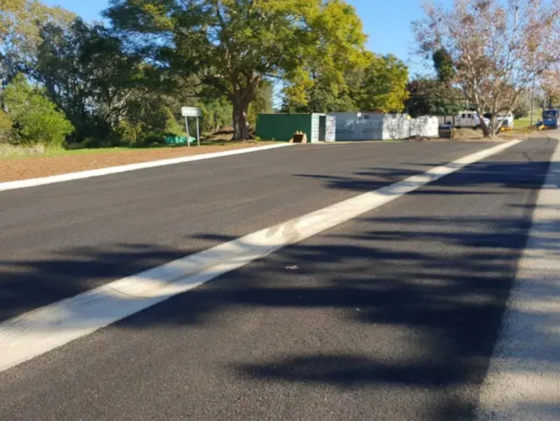 Newly Paved Asphalt Road with White Lane Markings — Jim Anderson Earthmoving Pty Ltd in Coopernook, NSW
