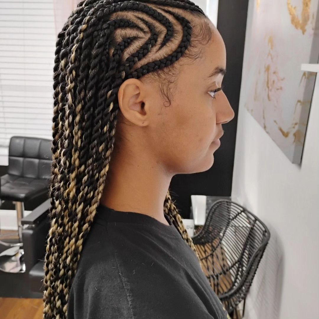 Woman with side twists and a decorative cornrow design on her scalp.