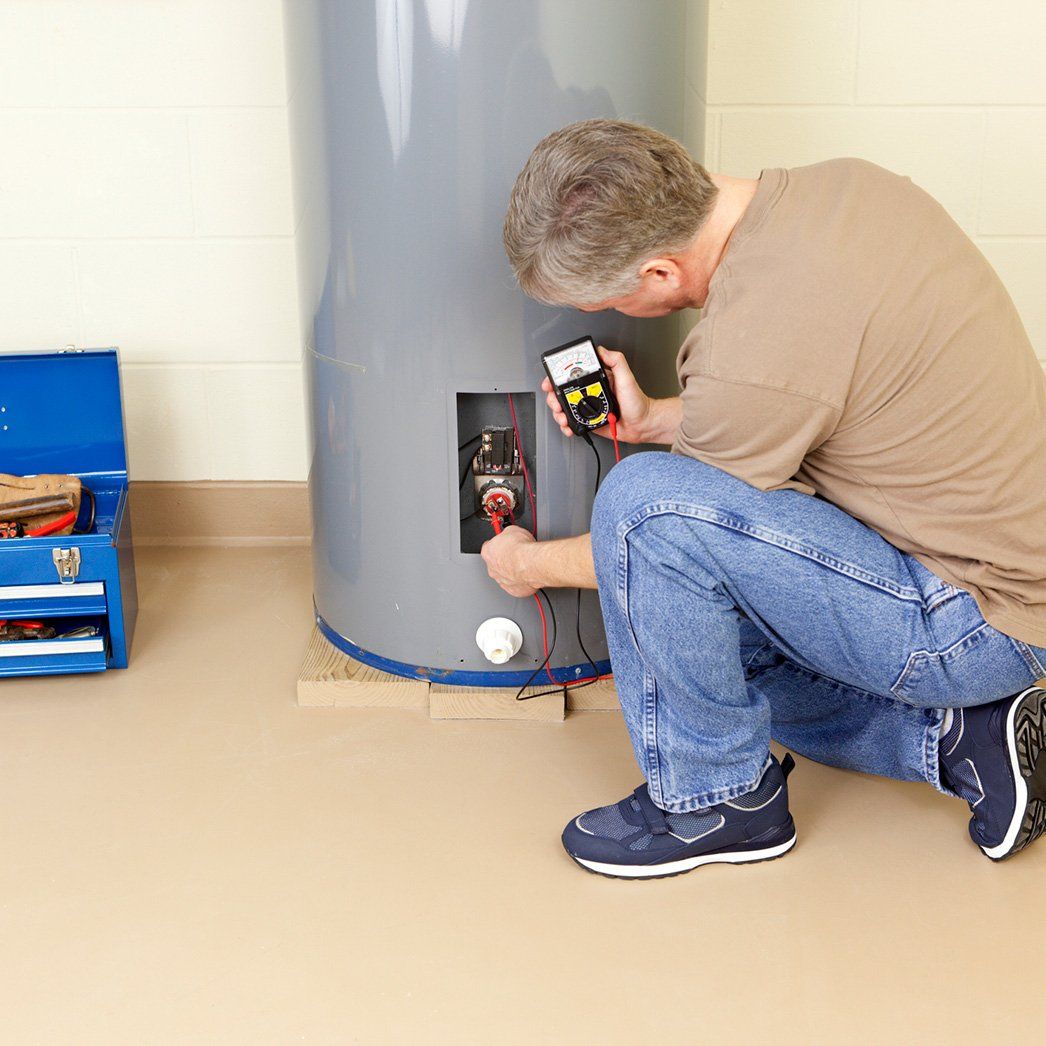 Plumber working in a water heater — Lexington, SC — Delta Plumbing LLC