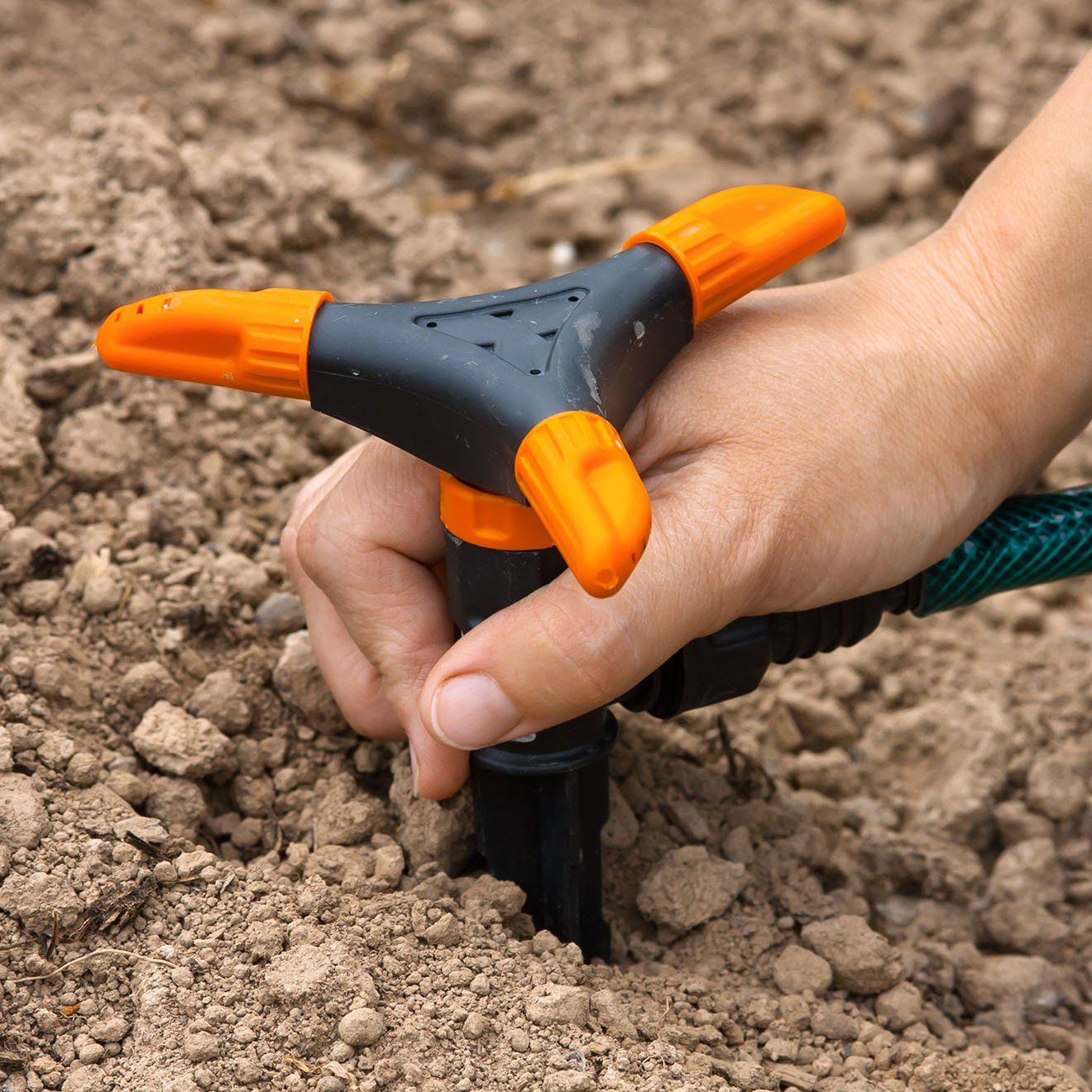 Hand installing sprinkler for irrigation — Lexington, SC — Delta Plumbing LLC