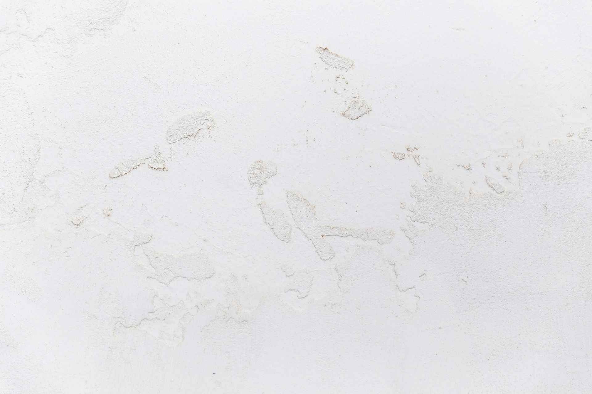 Faint beige stains or smudges on a white textured surface