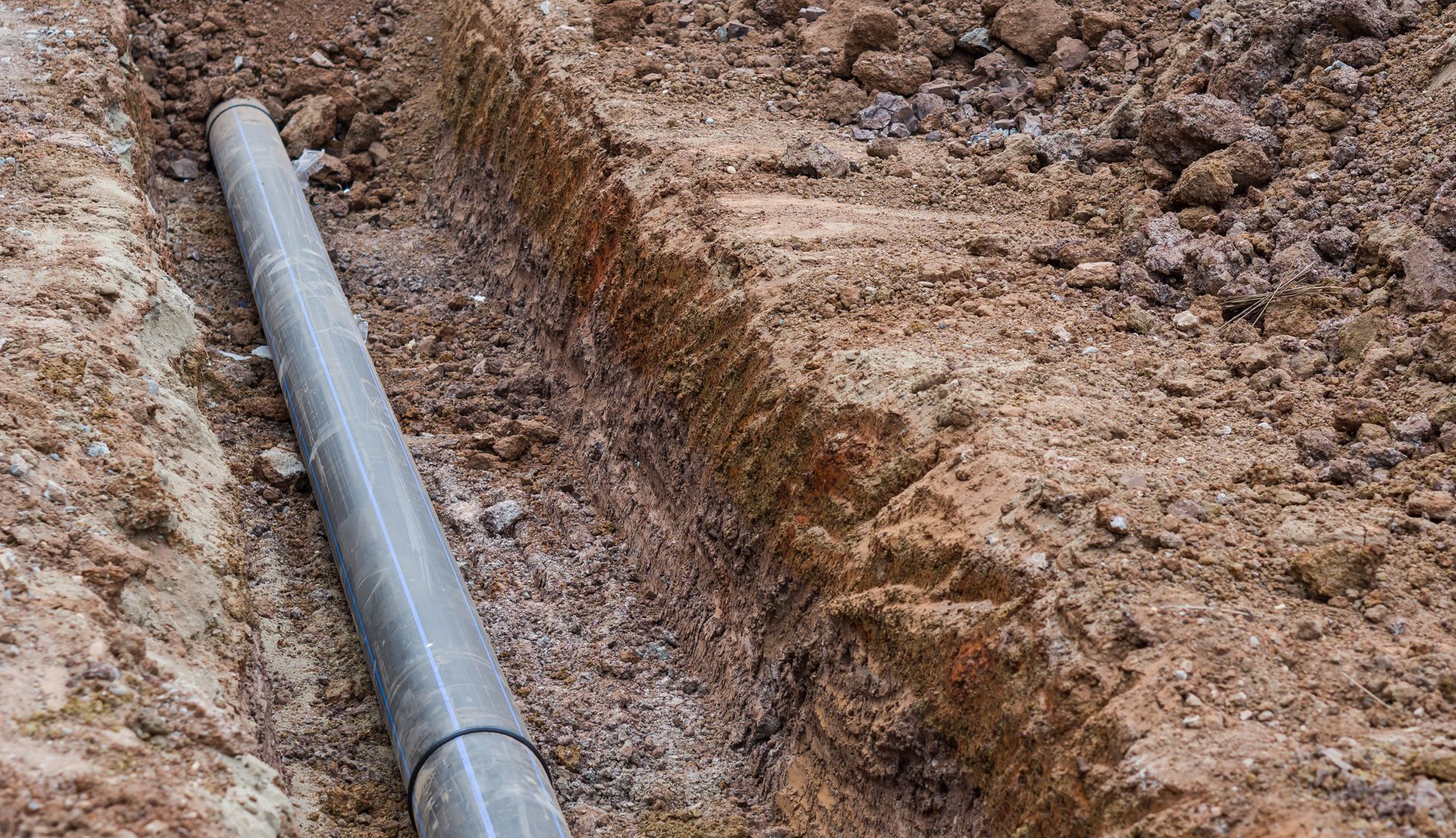 A Gray Pipe in a Brown Trench — Chief Structural Landscaping In Brisbane, QLD