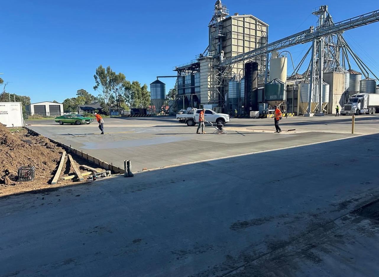 Construction Workers Pouring Concrete at a Grain Processing Facility — Chief Structural Landscaping In Brisbane, QLD