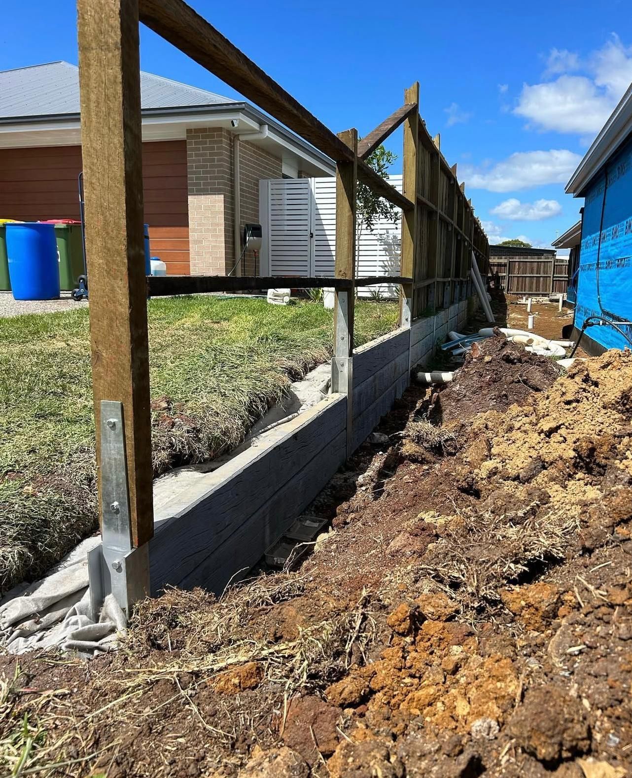 Wooden Fence Construction on a Brick Retaining Wall — Chief Structural Landscaping In Glenvale, QLD