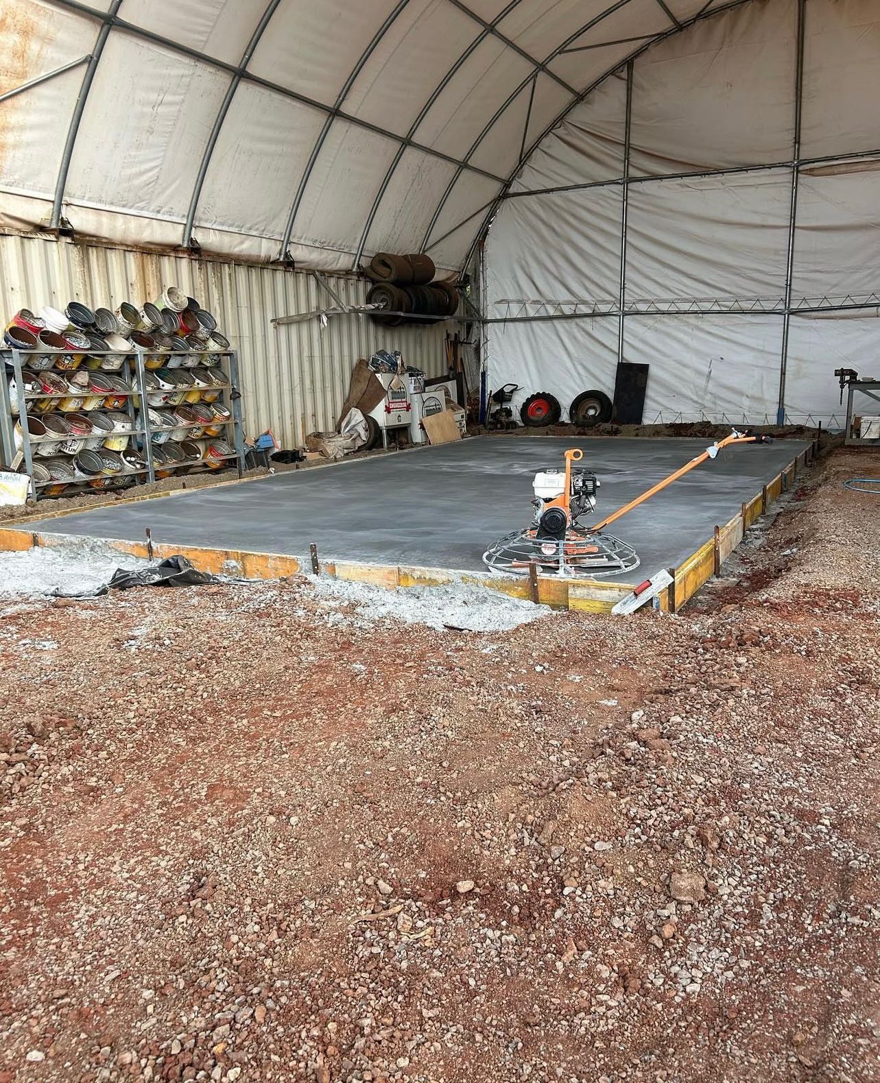 Freshly Poured Concrete Floor Inside a White Tent — Chief Structural Landscaping In Glenvale, QLD