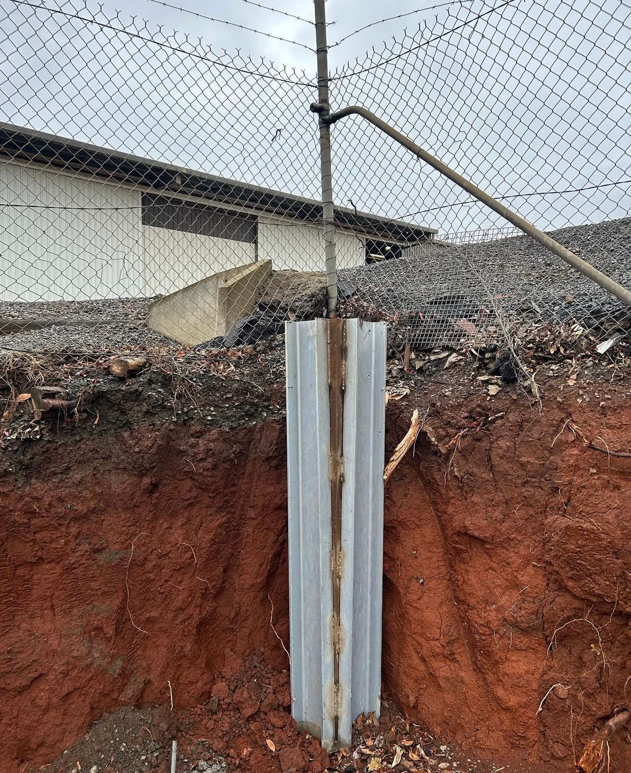 Chain-link Fence Post in an Excavated Area — Chief Structural Landscaping In Glenvale, QLD