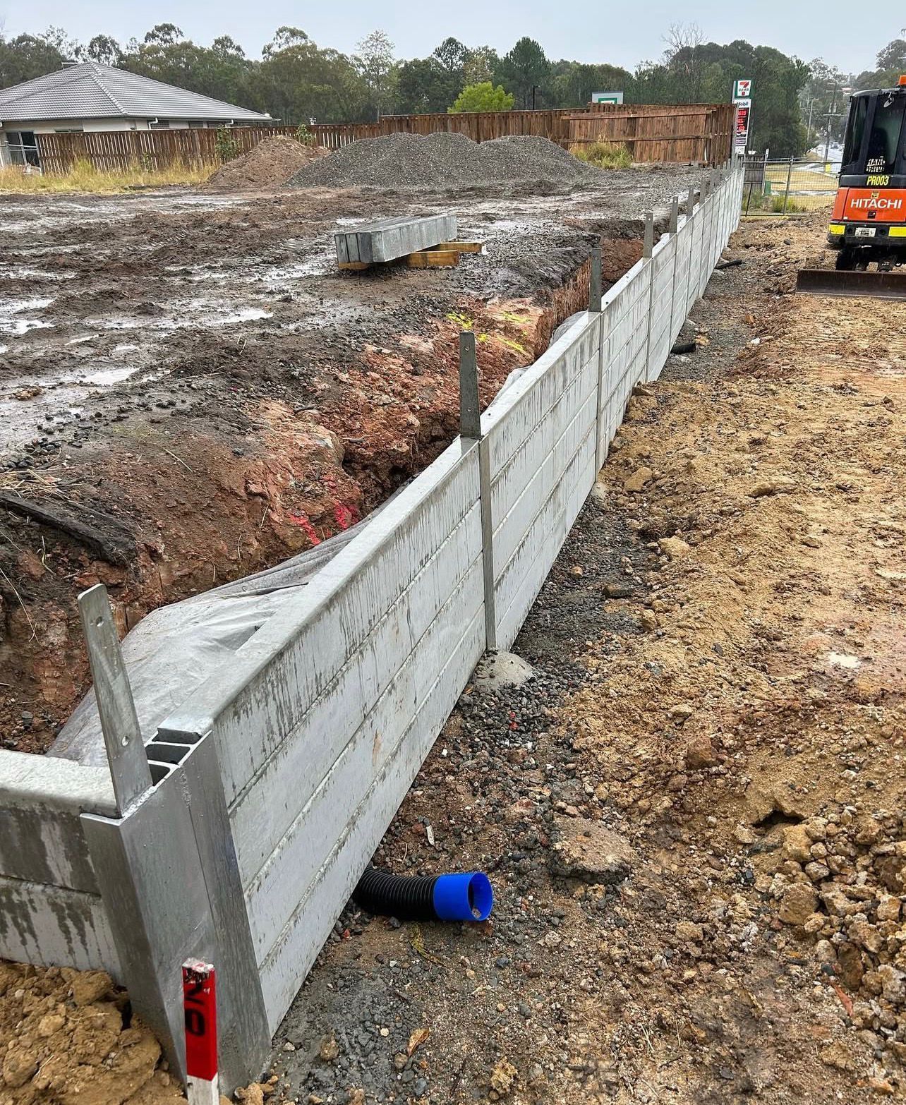 Construction Site With Concrete Retaining Wall, Soil, and Drainage Pipes — Chief Structural Landscaping In Glenvale, QLD
