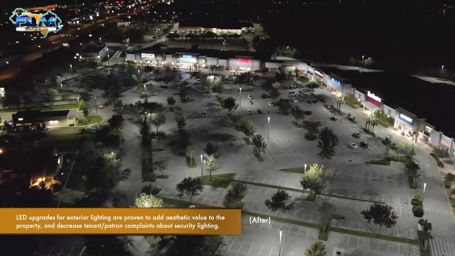 Aerial view of a brightly lit commercial parking lot at night. Buildings and trees are visible with text overlay.