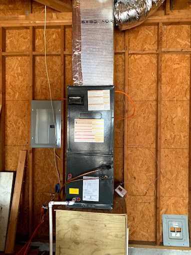 A picture of an air conditioner in a house under construction.