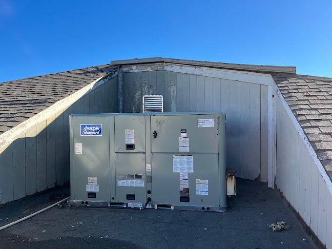 A large box is sitting on the roof of a building.
