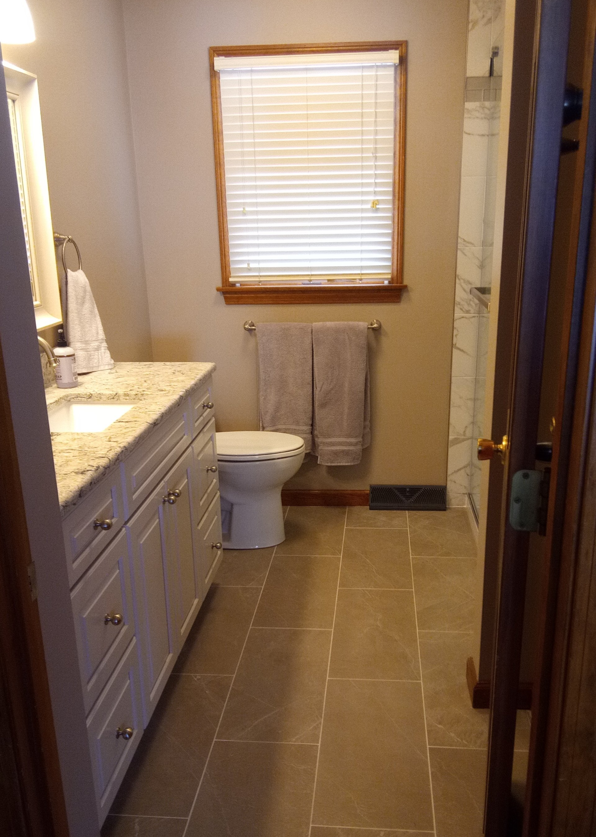 Photo of completed bathroom remodel with tile flooring