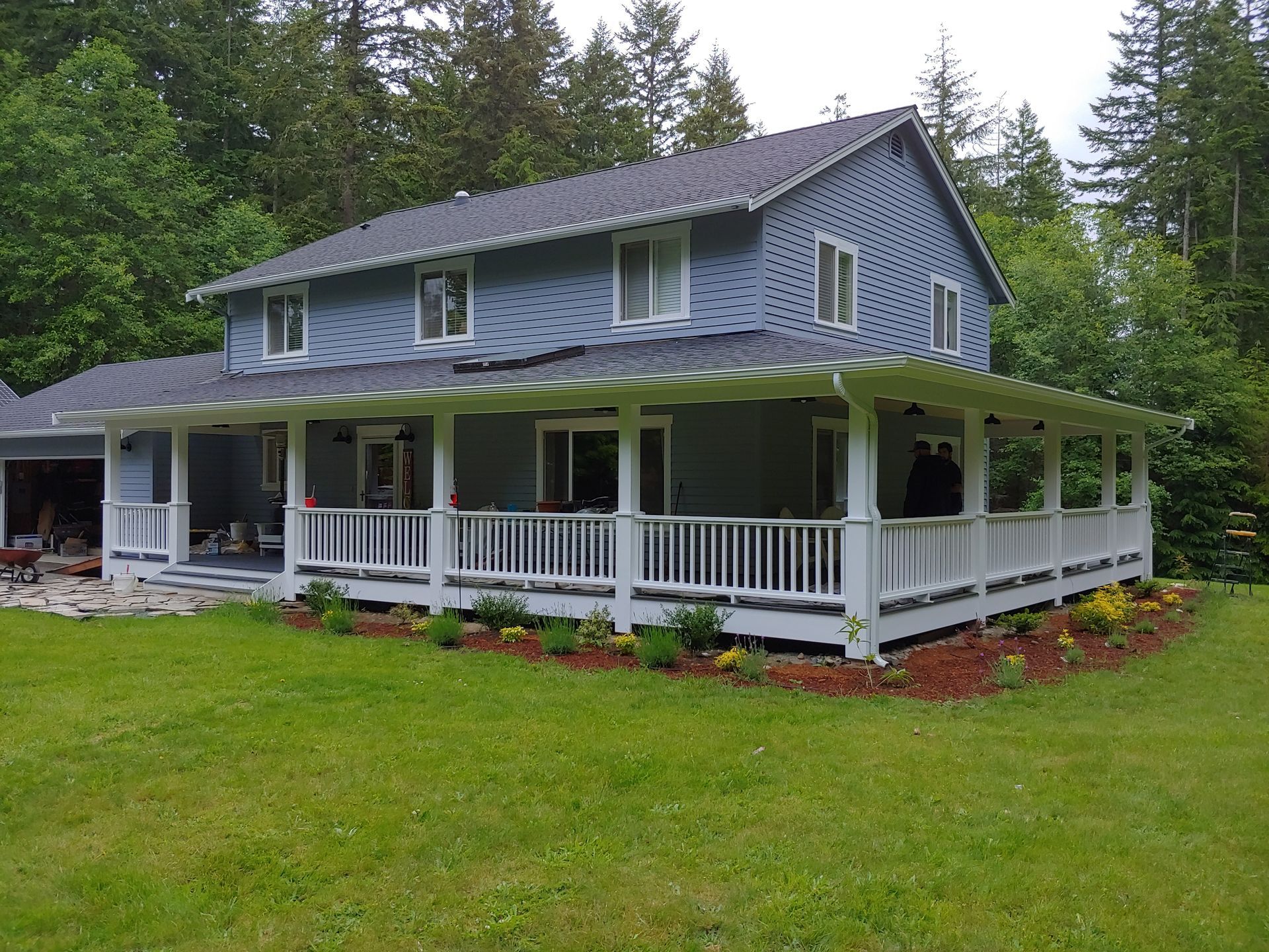A large house with a large porch and a lot of windows