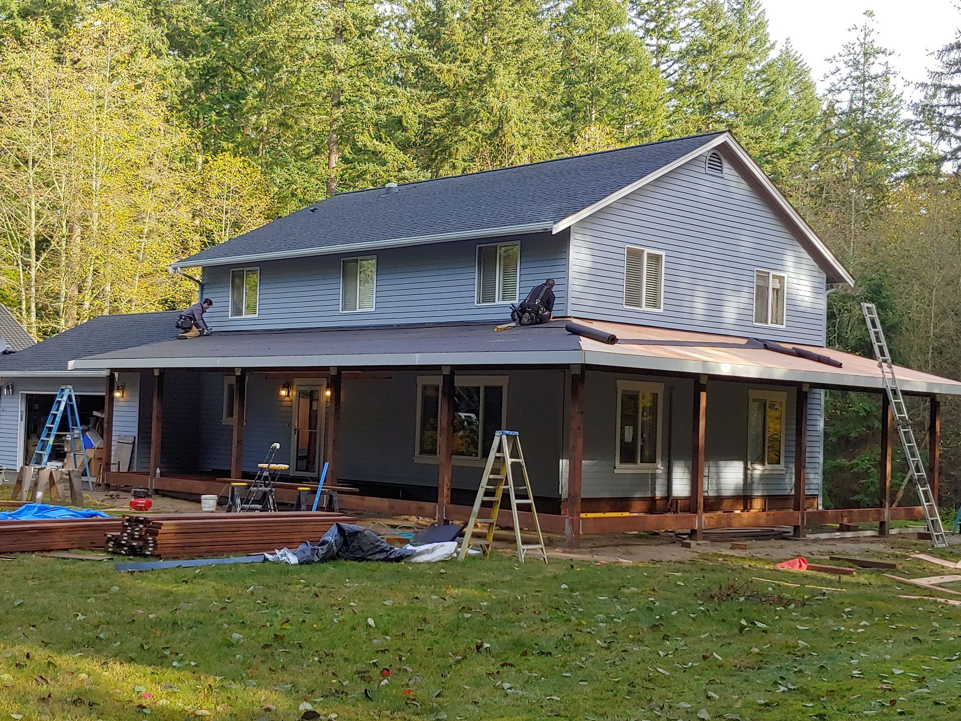 A large house with a porch is being remodeled.