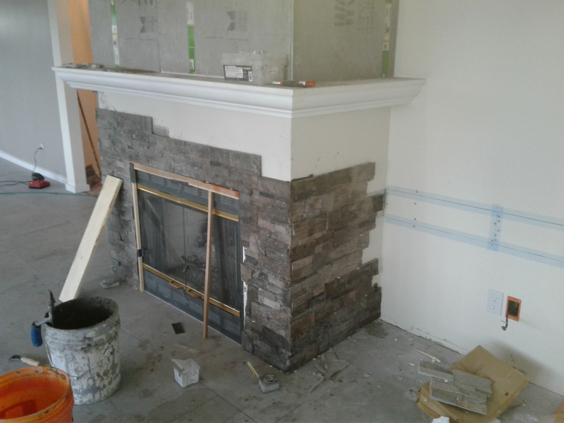 A fireplace is being remodeled in a living room