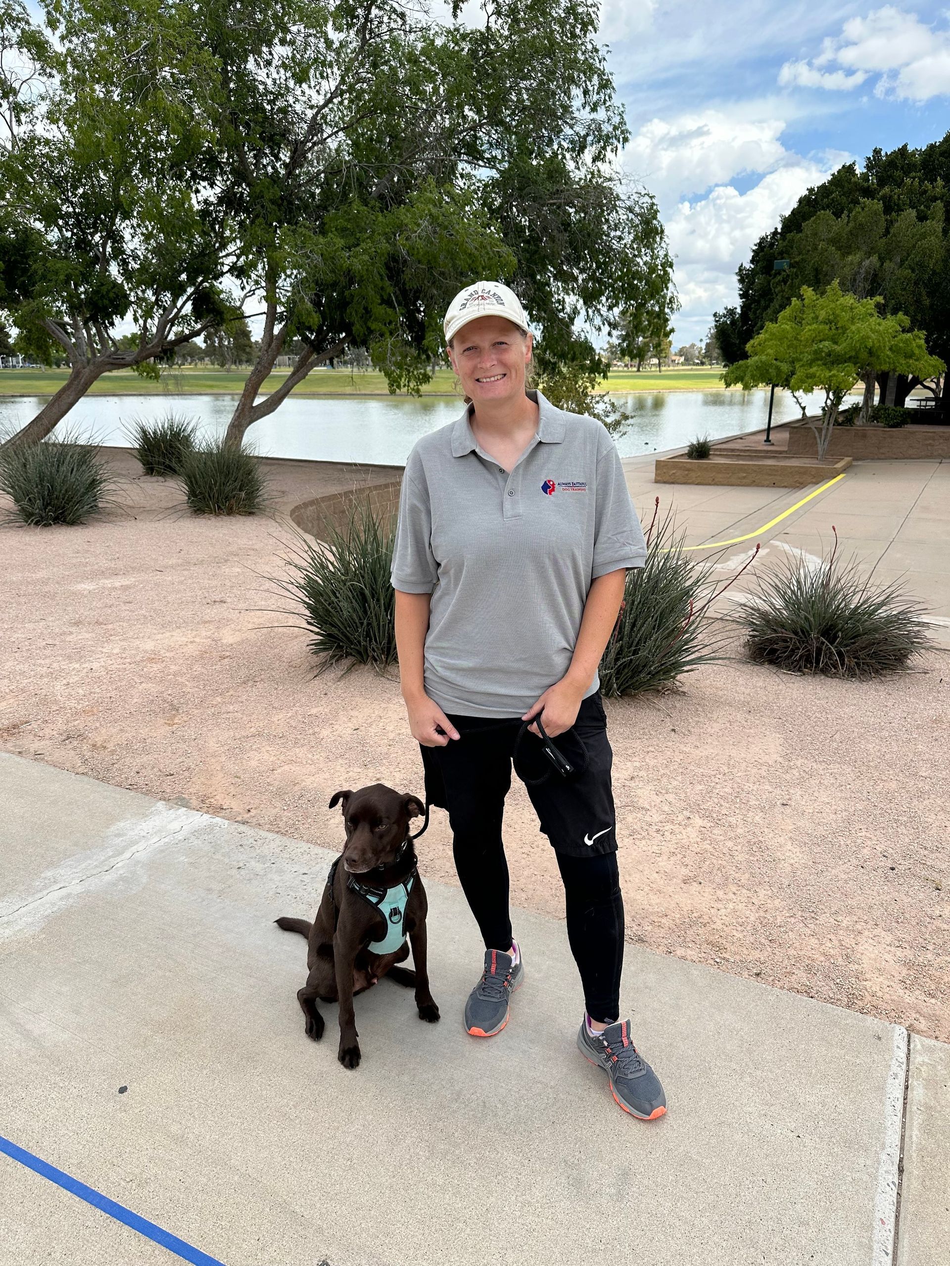 A man is standing next to a dog on a leash.