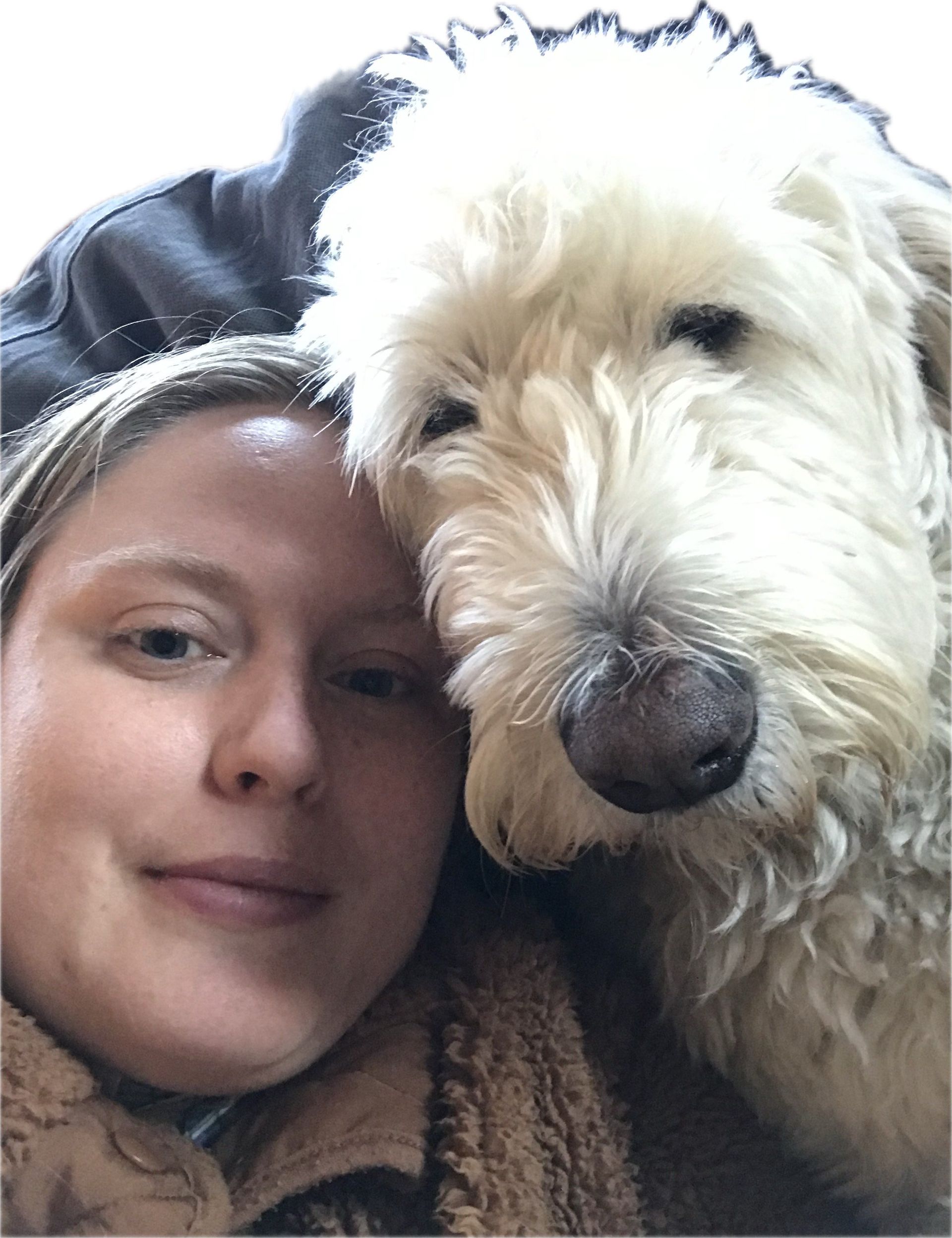 A woman and her dog are posing for a picture