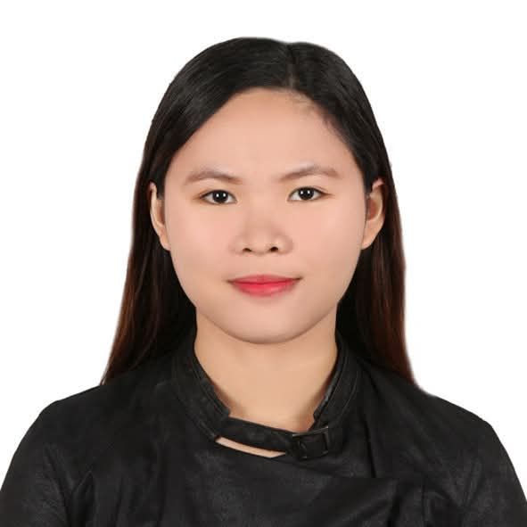Studio portrait of a woman with long black hair wearing a black top on a white background