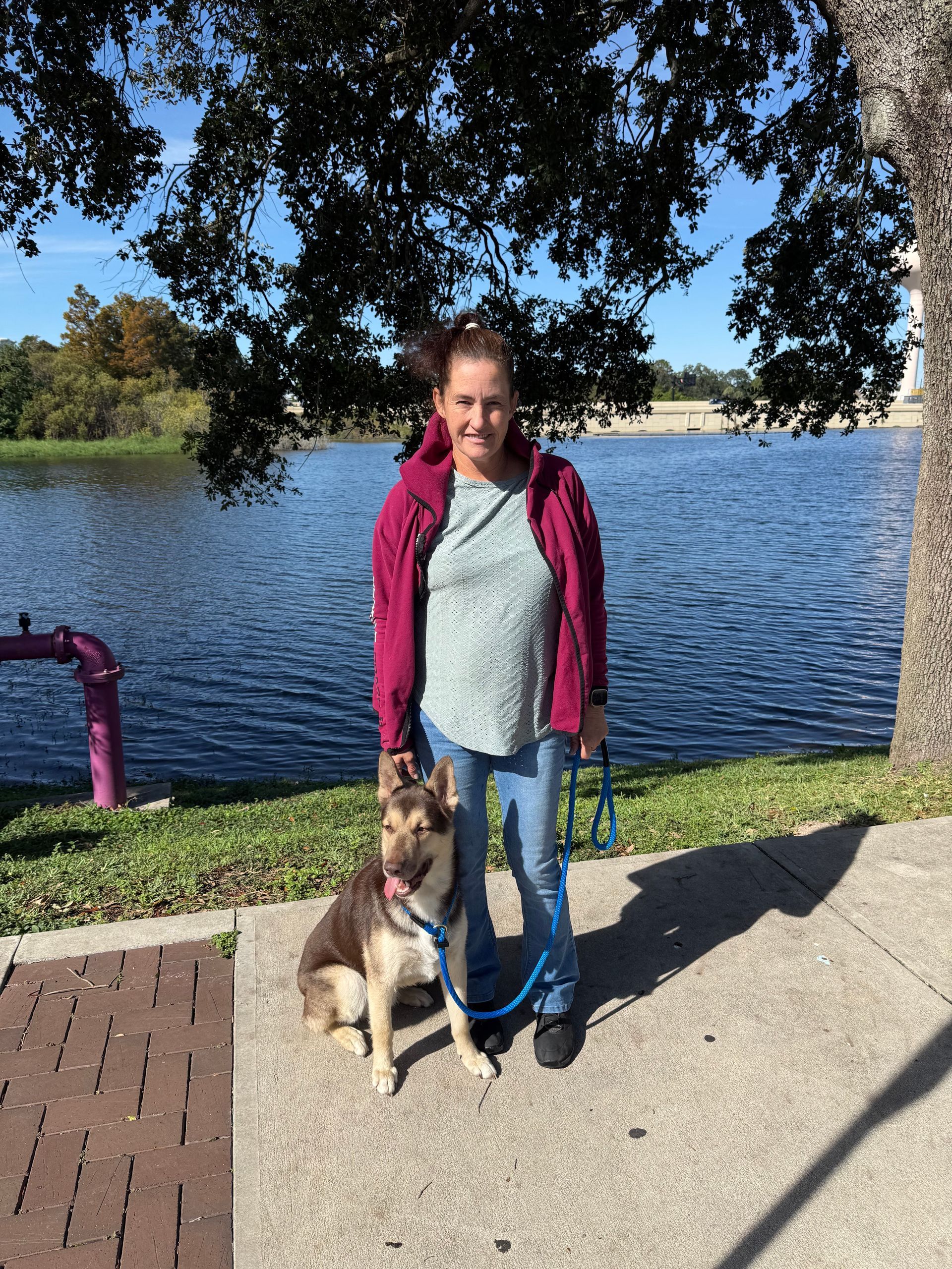 A woman in a plaid shirt is taking a selfie.