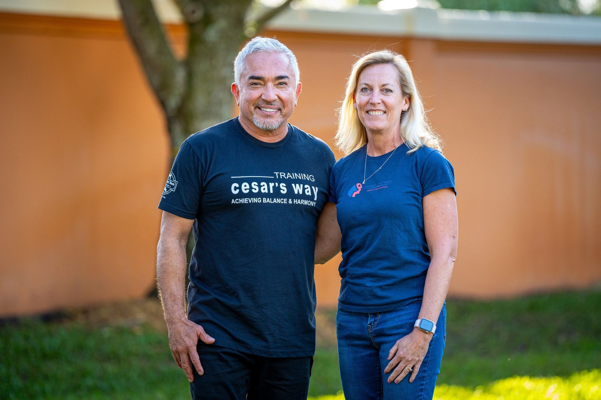 A man and a woman are standing next to each other in front of a building.