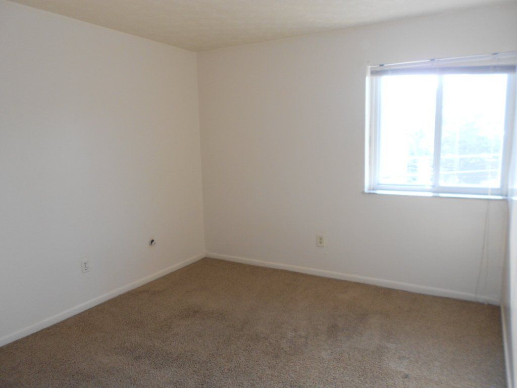 31-35-e-12th-ave- Bedroom with window and carpet