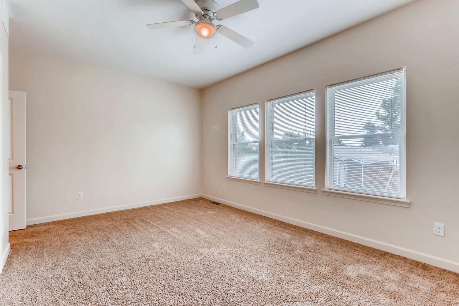 30-38-w-9th-ave- Bedroom with windows and ceilling fan