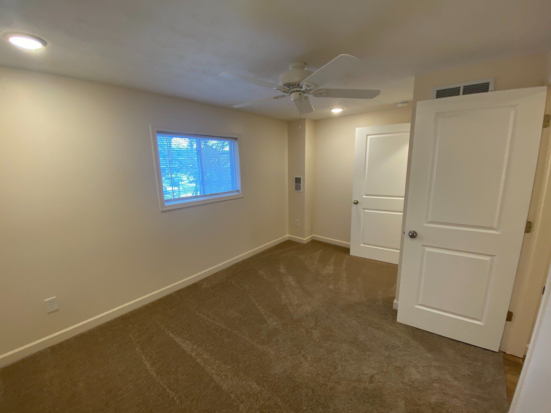 spacious carpeted bedroom