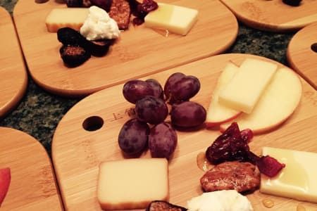 Cheese boards with grapes, cheese, and dried fruit.