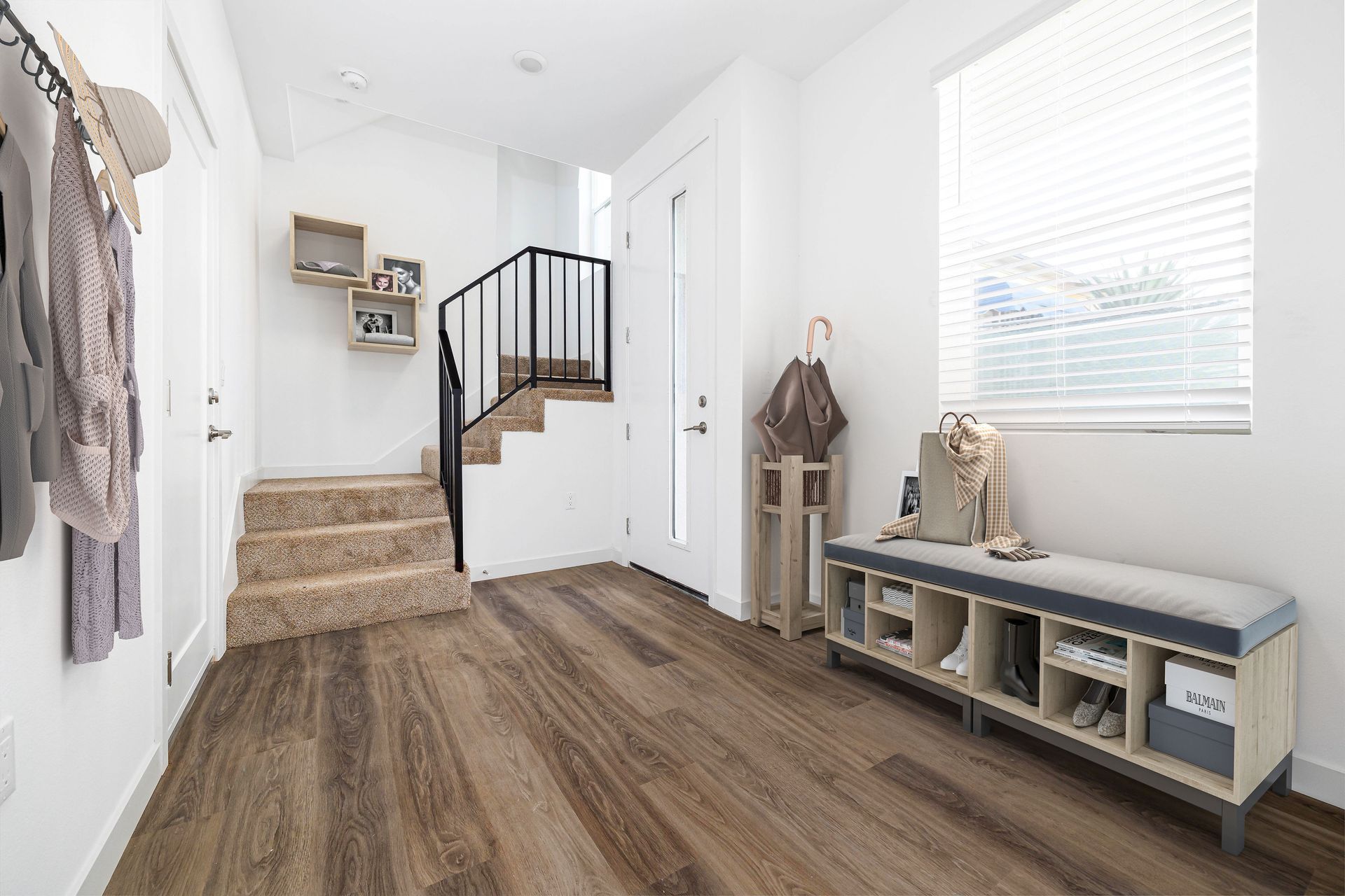 a hallway with hardwood floors and stairs in a house .