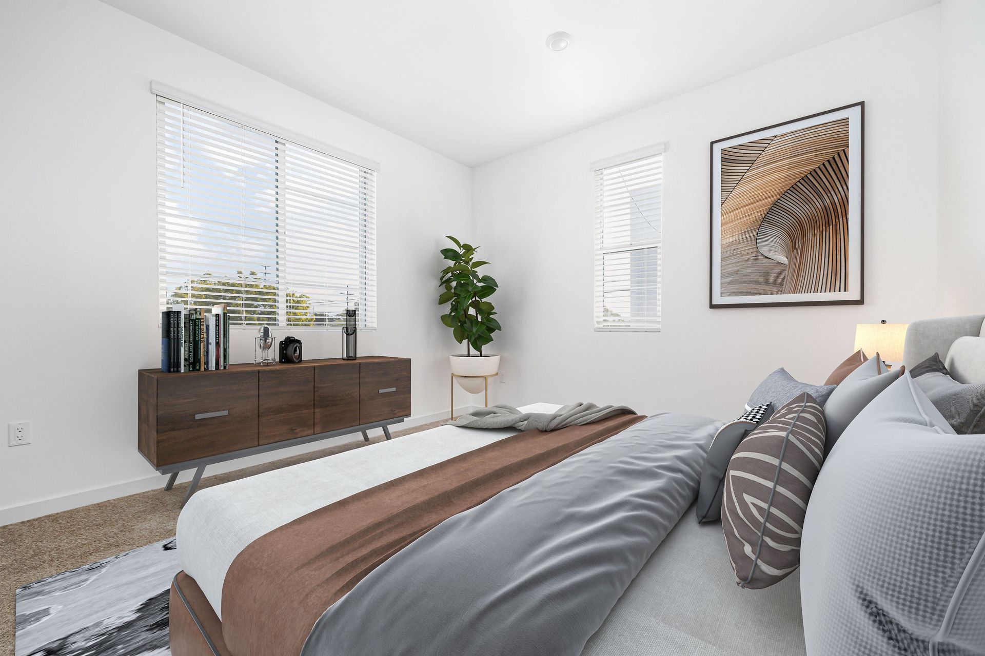 a bedroom with a large bed and a picture on the wall .