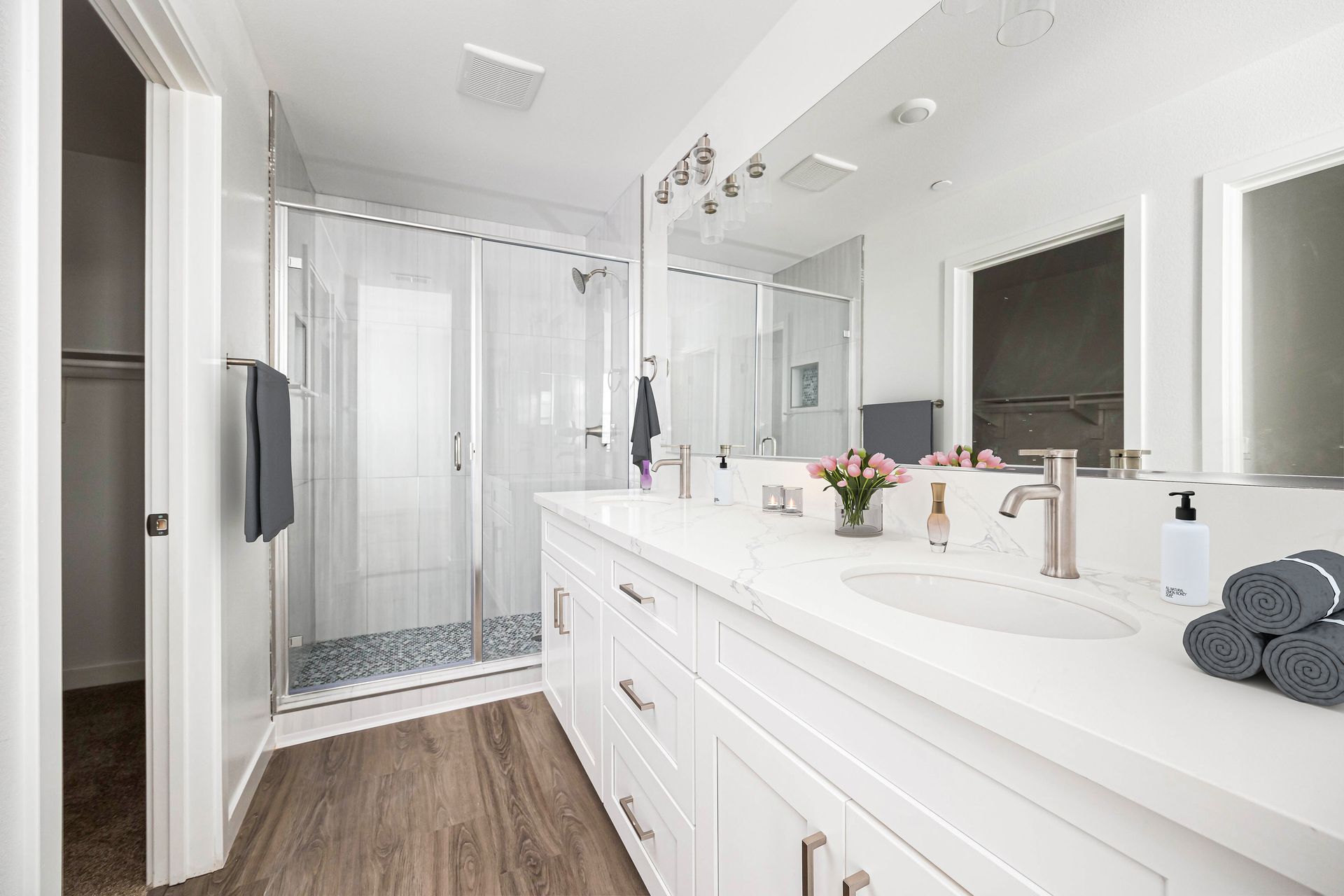 a bathroom with two sinks and a walk in shower .