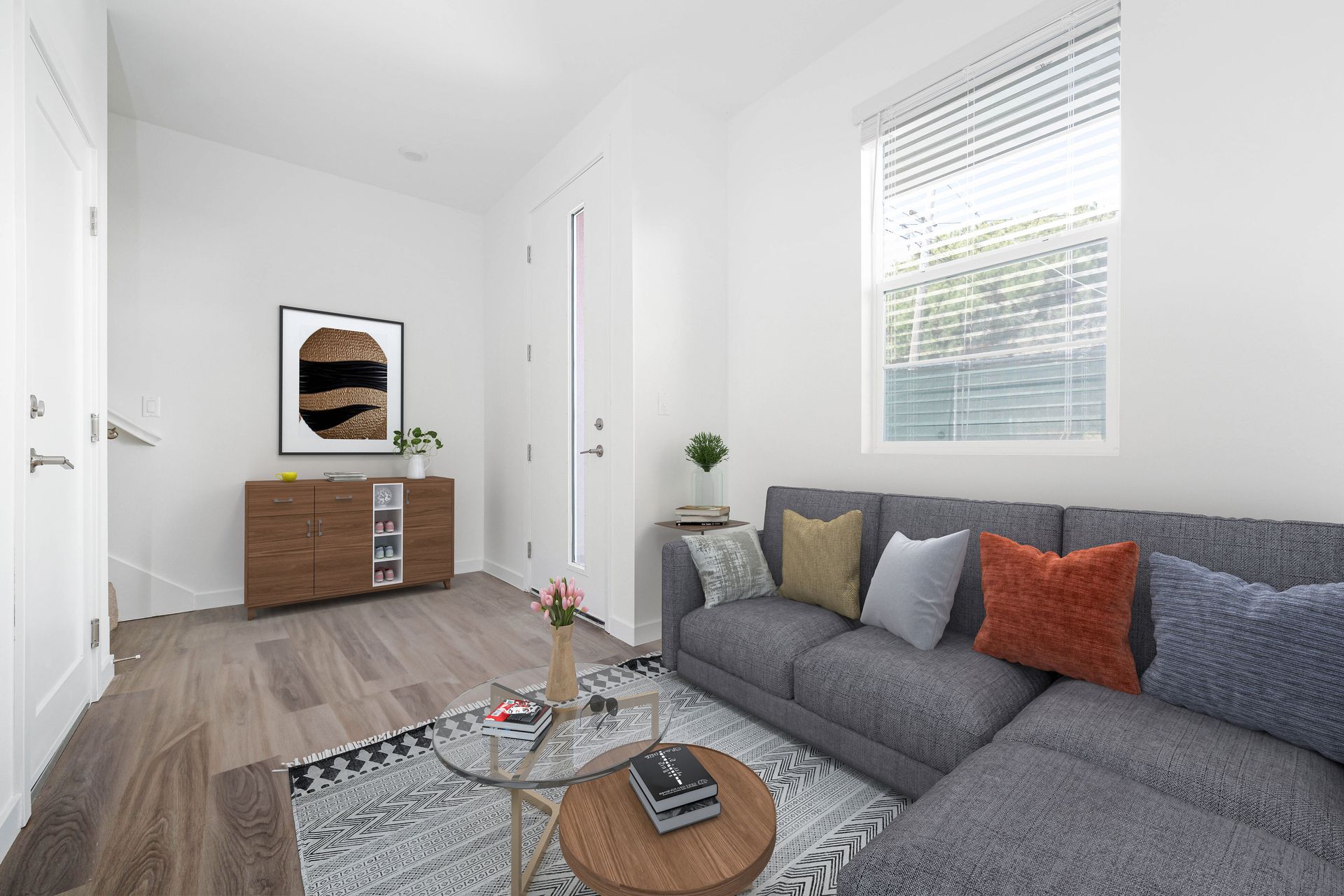 a living room with a couch , table , and window .