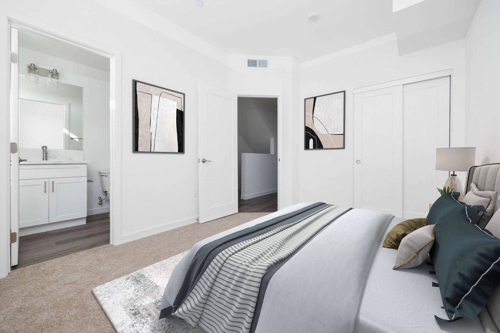 a bedroom with a large bed and a bathroom