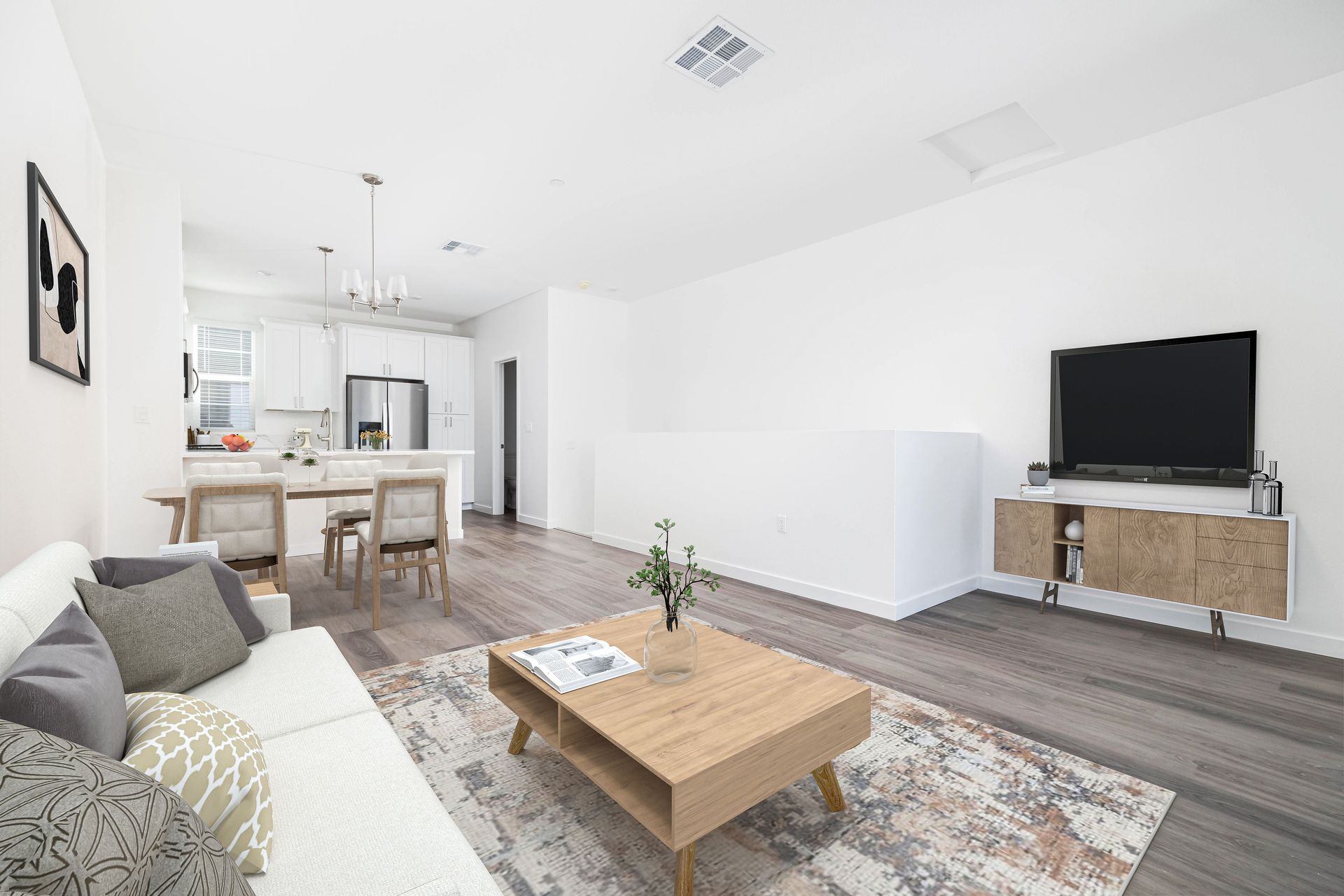 a living room with a couch , coffee table , and television .