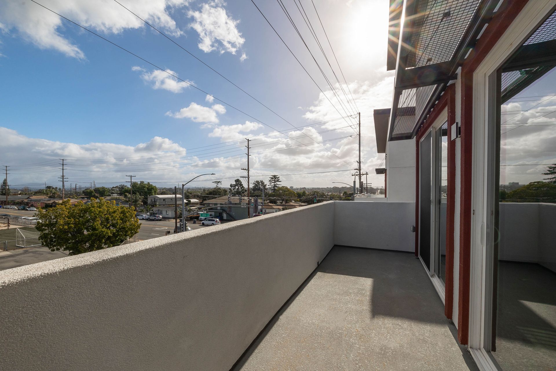 a balcony with a view of a city on a sunny day