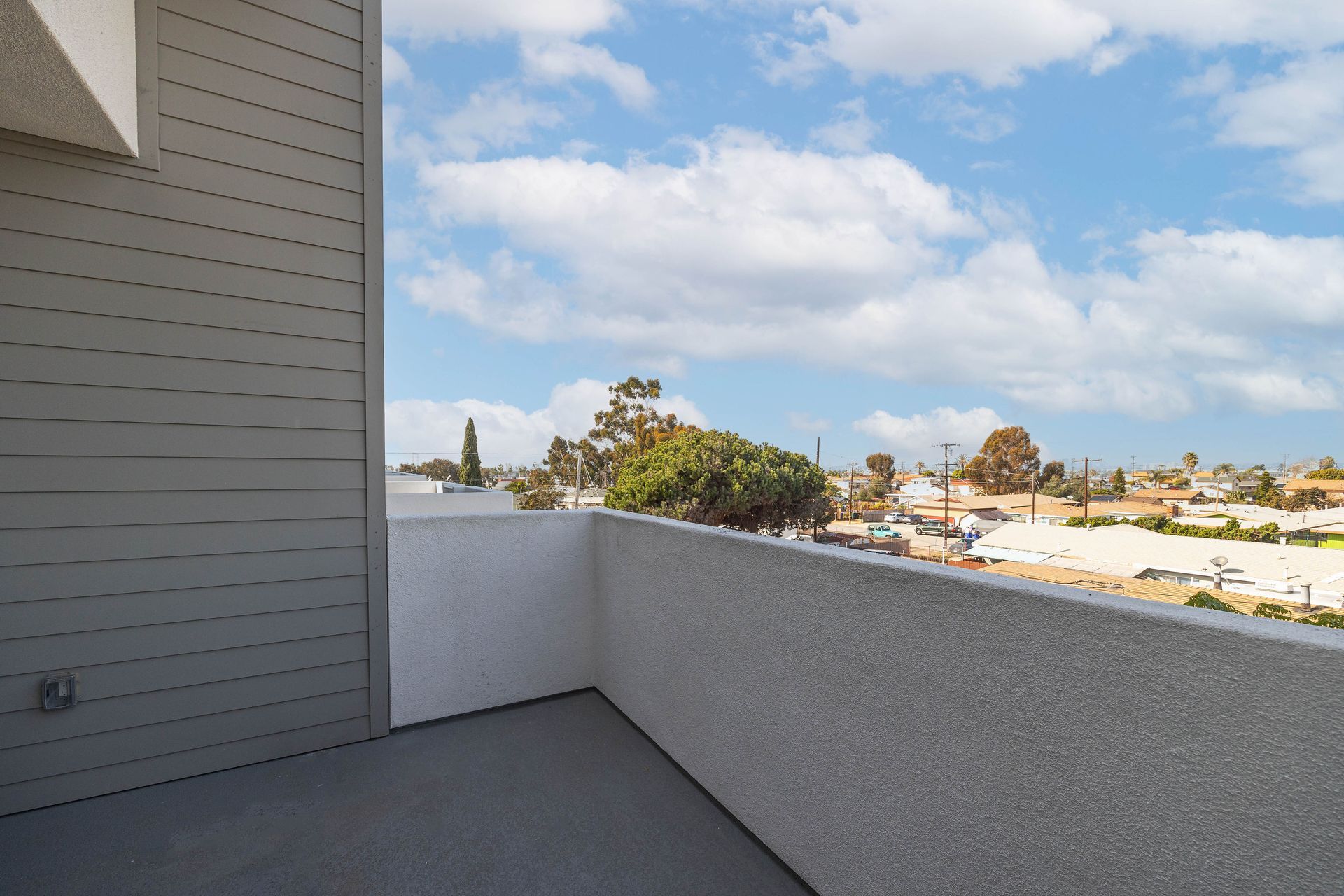 an empty balcony with a view of a city