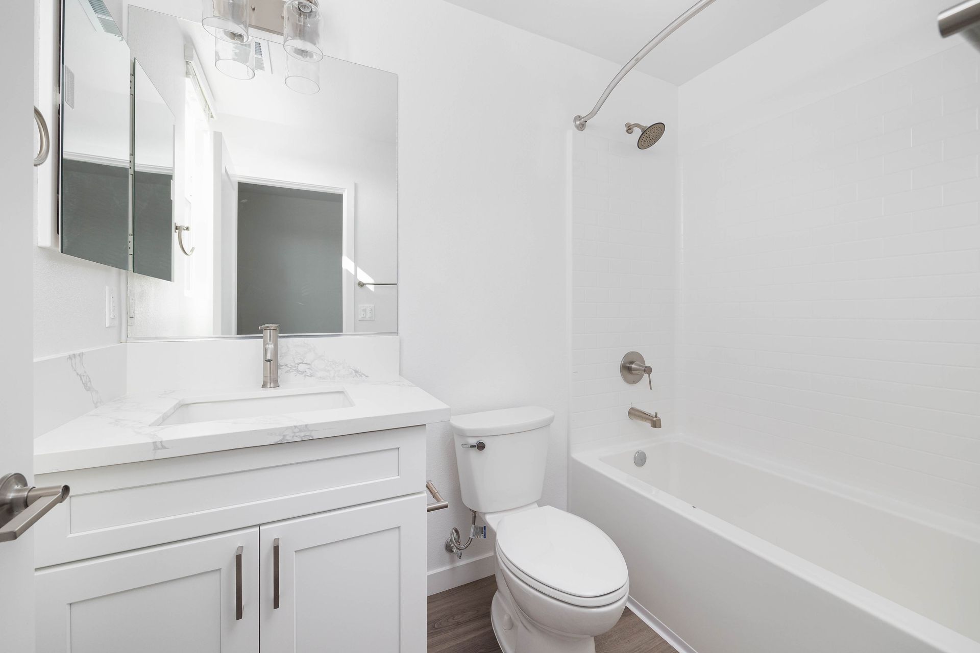 a bathroom with a toilet , sink , and bathtub .