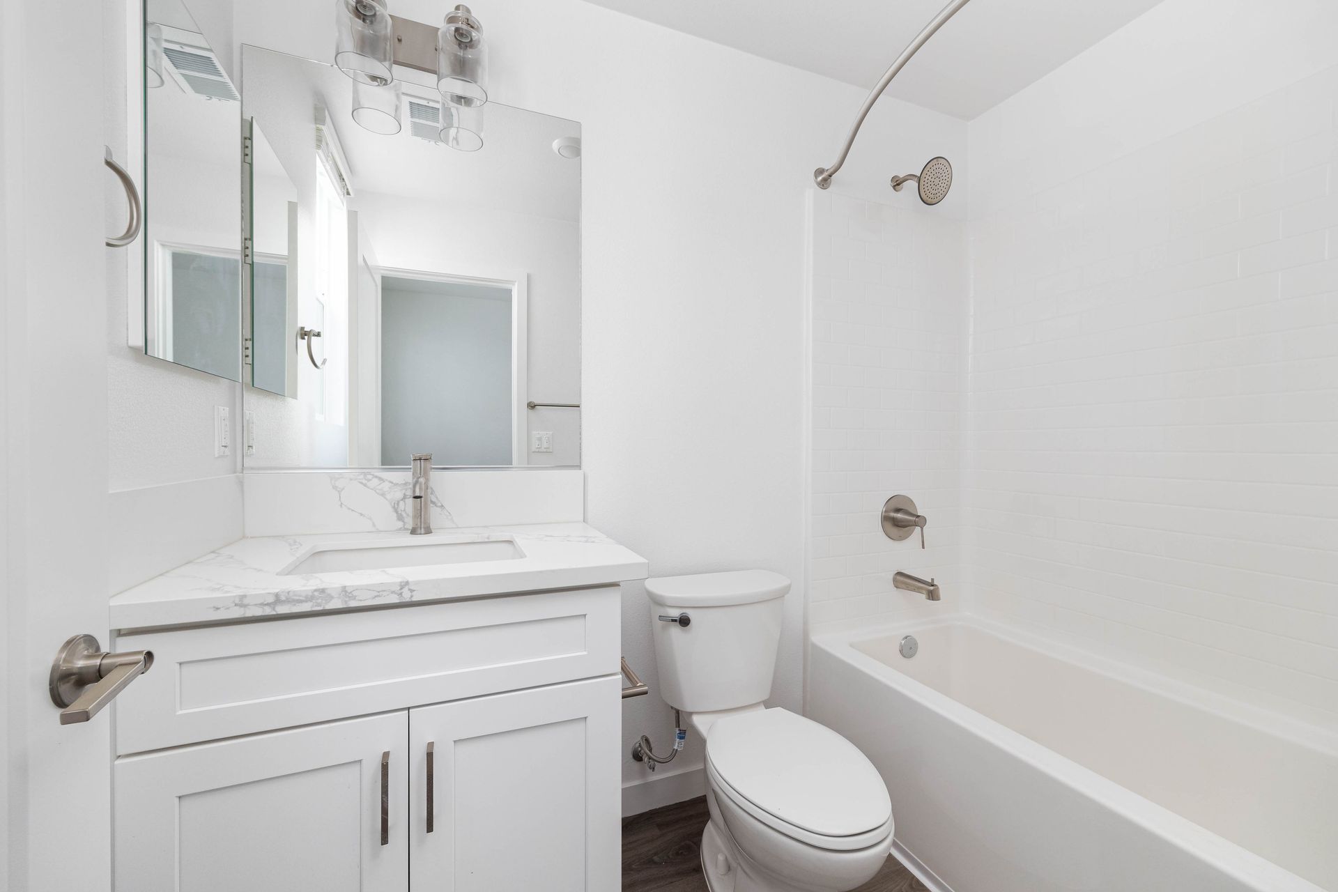 a bathroom with a toilet , sink , and bathtub .