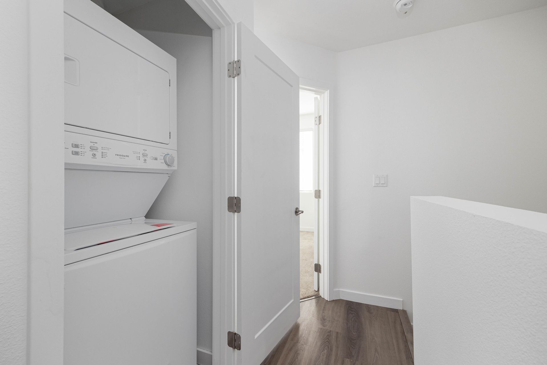 a washer and dryer are stacked on top of each other in a laundry room .
