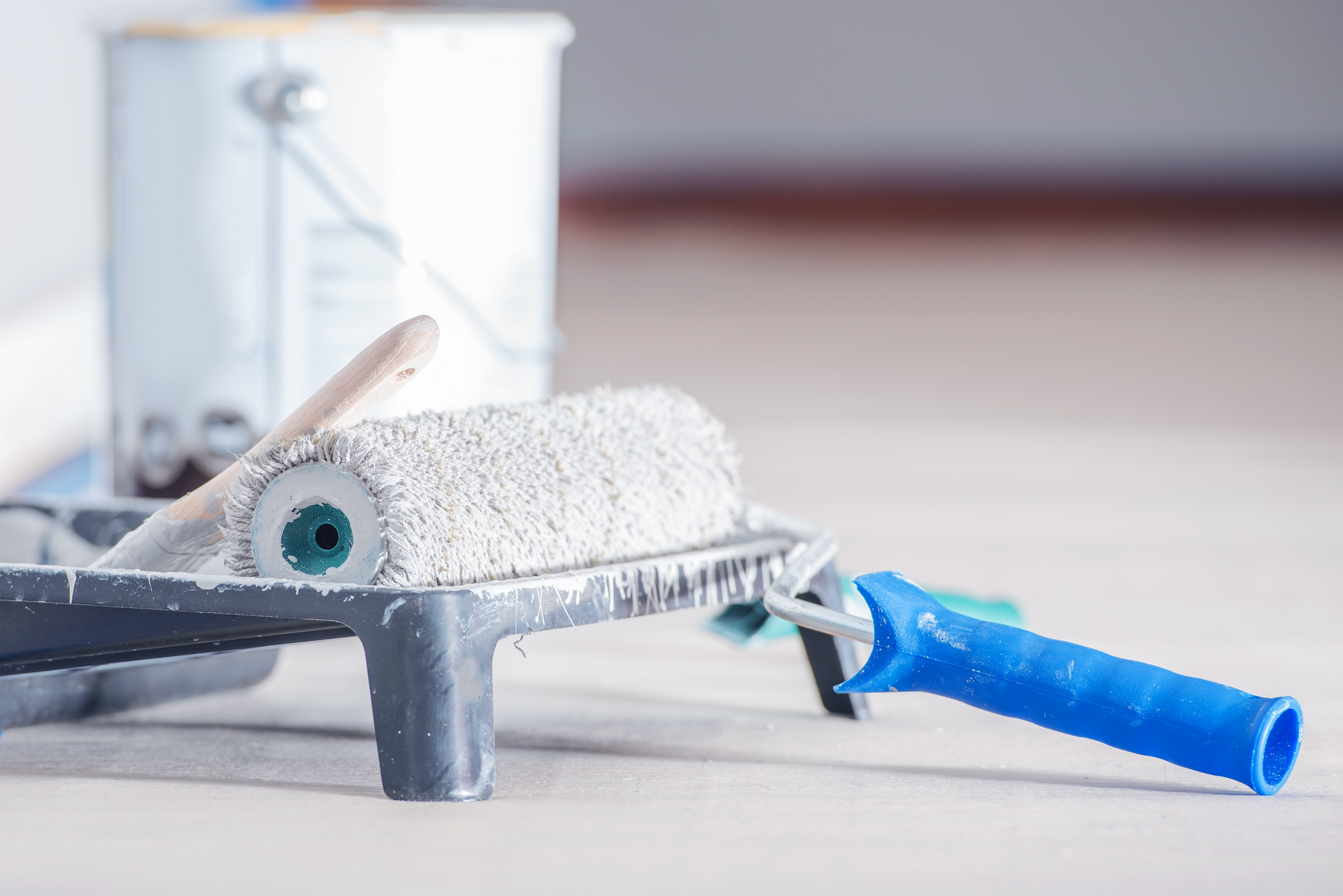 A man wearing a hard hat and safety vest is working on a roof.