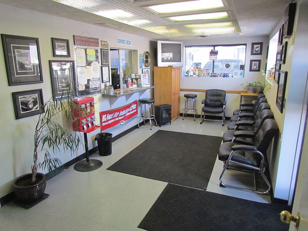 Waiting area with a counter, chairs, and a TV.