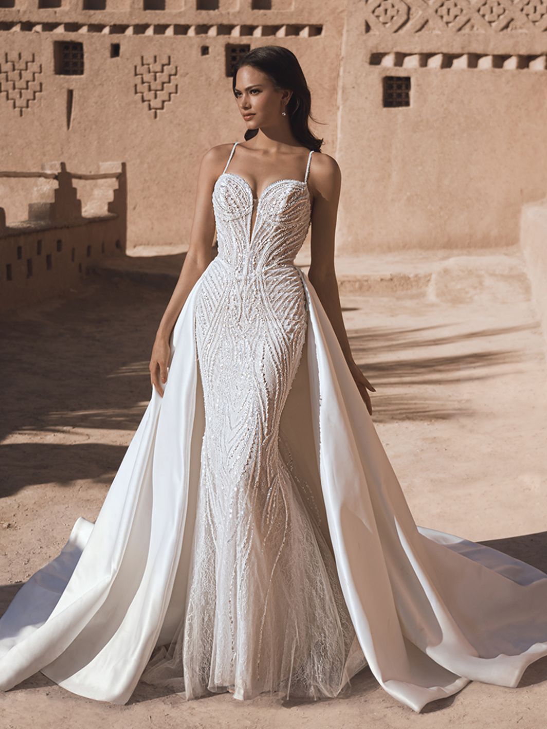 Model wearing an Blue By Enzoani wedding dress