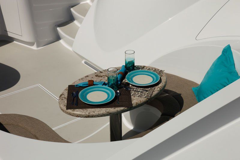 A table with plates and glasses on it on a boat