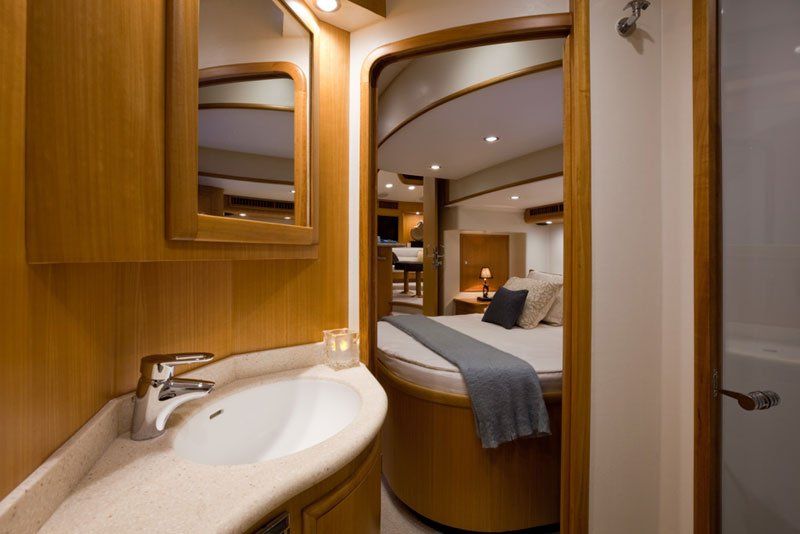 A bathroom on a boat with a sink and a mirror