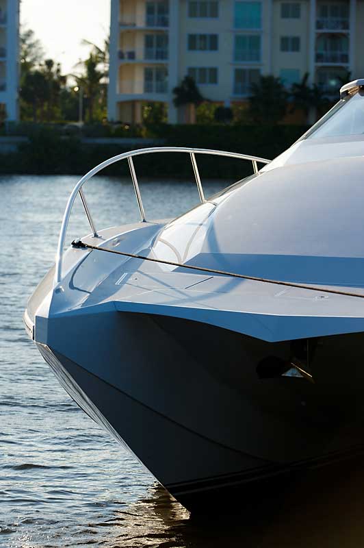 A boat is docked in the water with a building in the background